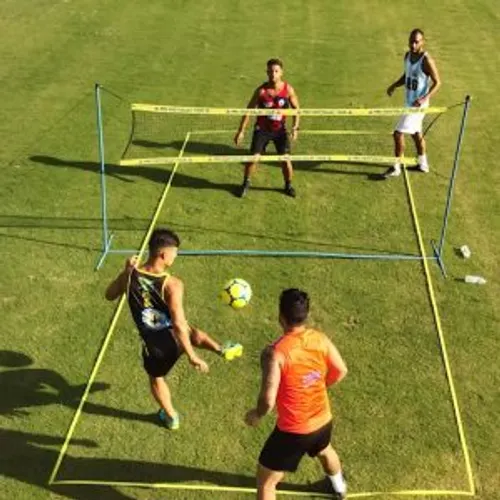 Football tennis players playing over a low net